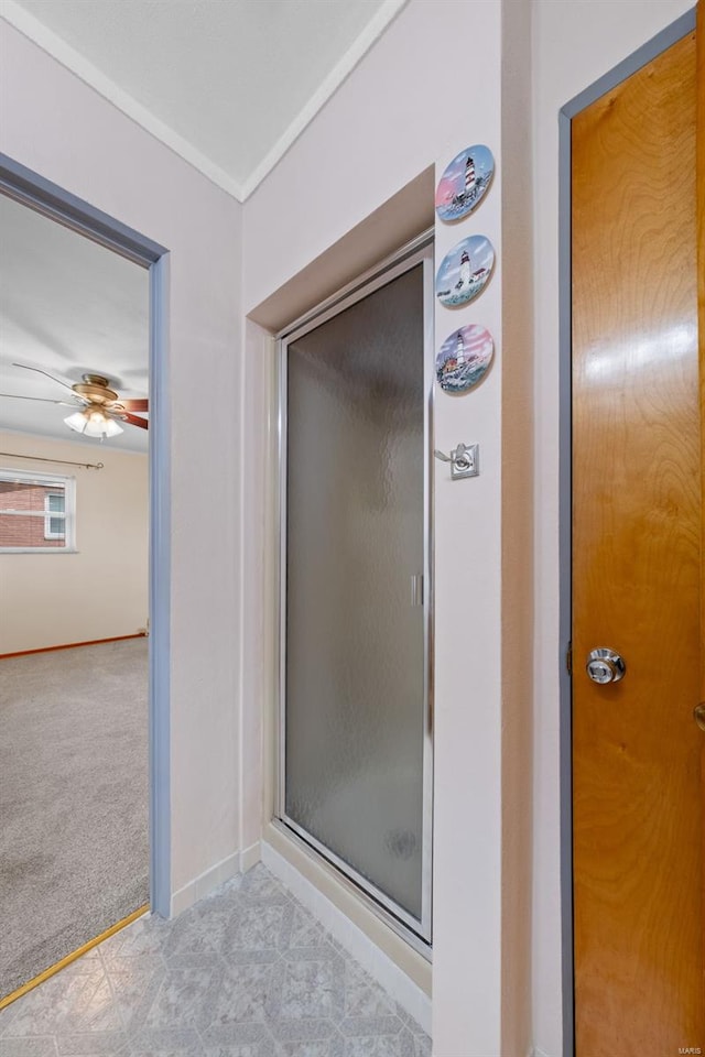 bathroom featuring a stall shower and baseboards
