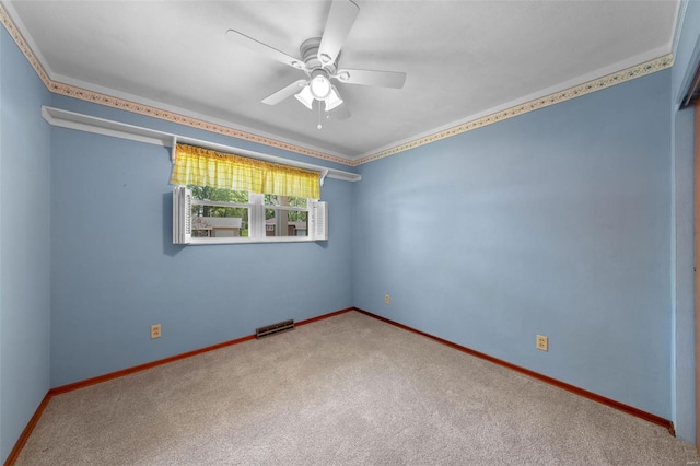 carpeted empty room with baseboards, visible vents, and ceiling fan