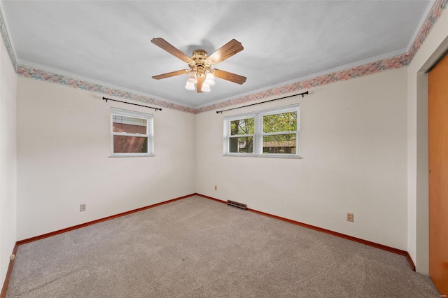 spare room with a ceiling fan, carpet flooring, and baseboards