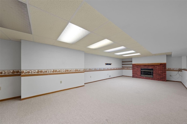 interior space with baseboards, a fireplace, and carpet flooring
