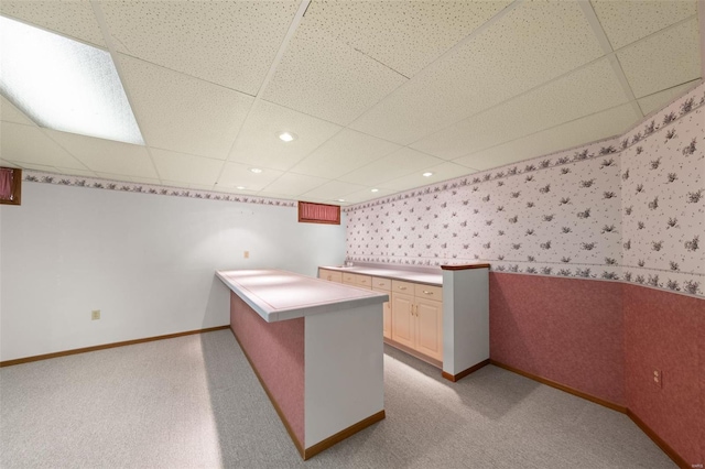 interior space featuring wallpapered walls, baseboards, a drop ceiling, recessed lighting, and light carpet