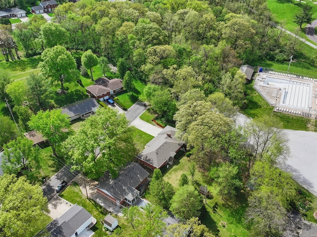 drone / aerial view with a forest view and a residential view