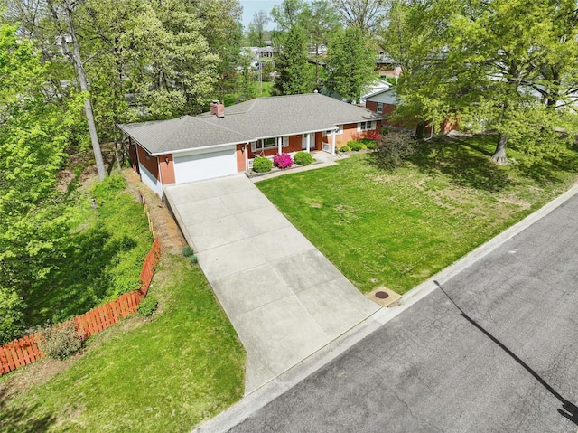 ranch-style house with a porch, fence, driveway, a front lawn, and an attached garage