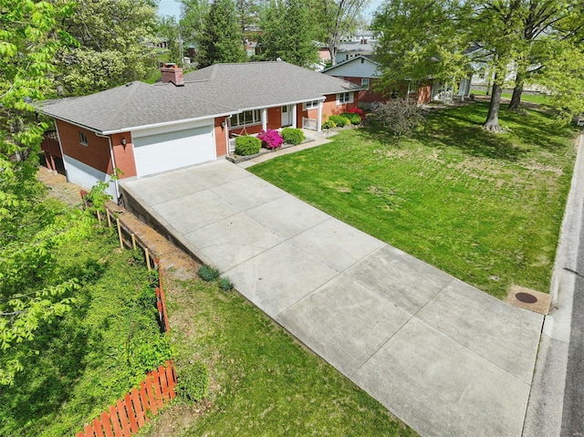 single story home with driveway, a chimney, an attached garage, fence, and a front lawn