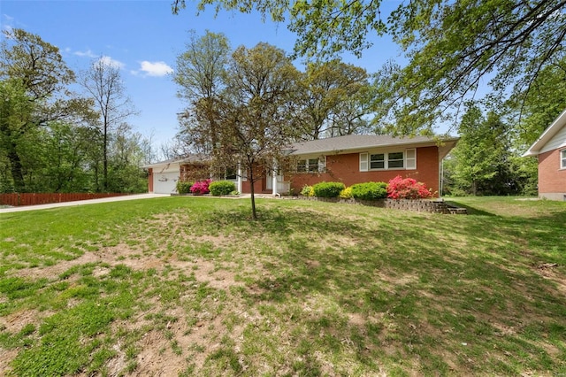 single story home with a front lawn, a garage, and brick siding
