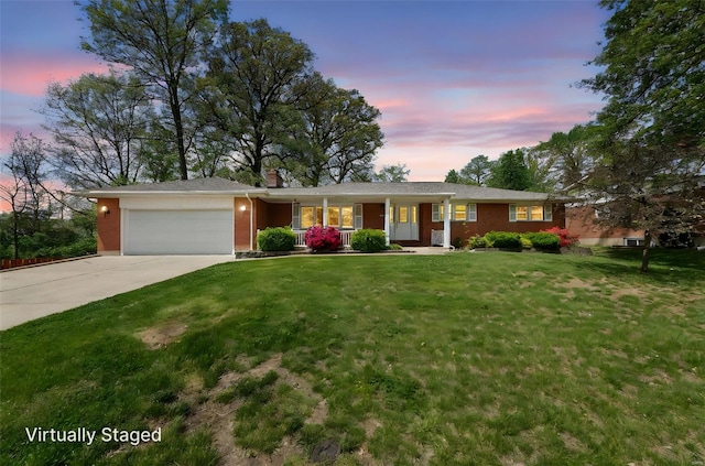 ranch-style house featuring a porch, a yard, brick siding, concrete driveway, and an attached garage