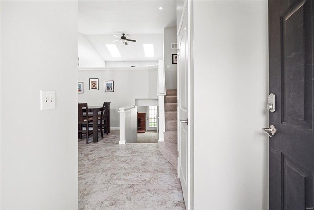 hallway with stairs and a skylight