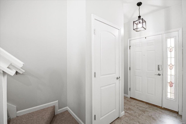 entrance foyer featuring stairway, baseboards, and plenty of natural light