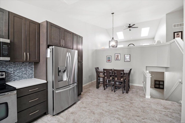 kitchen with appliances with stainless steel finishes, dark brown cabinets, ceiling fan, visible vents, and lofted ceiling with skylight