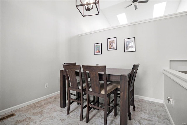 dining room with ceiling fan with notable chandelier, baseboards, and visible vents