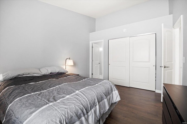 bedroom with a closet and dark wood-style floors