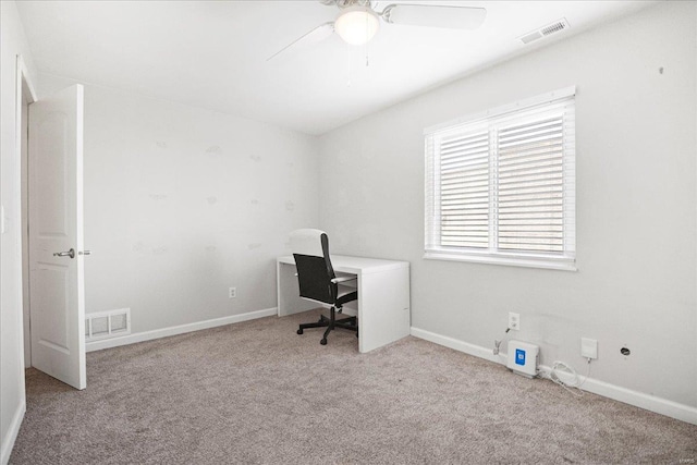 unfurnished office featuring baseboards, visible vents, carpet flooring, and ceiling fan
