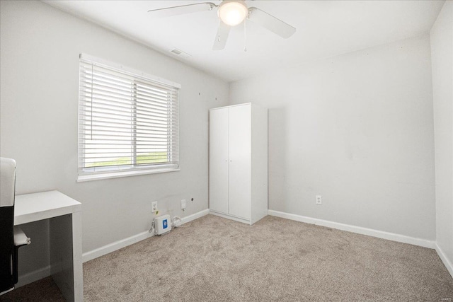 unfurnished bedroom with carpet, visible vents, a ceiling fan, and baseboards
