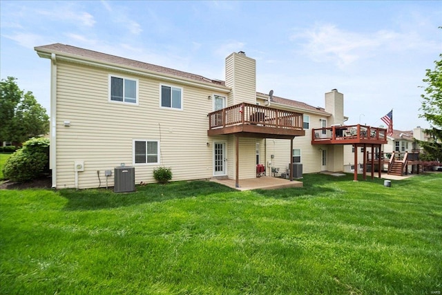 back of property featuring a lawn, a deck, a patio, and central AC unit