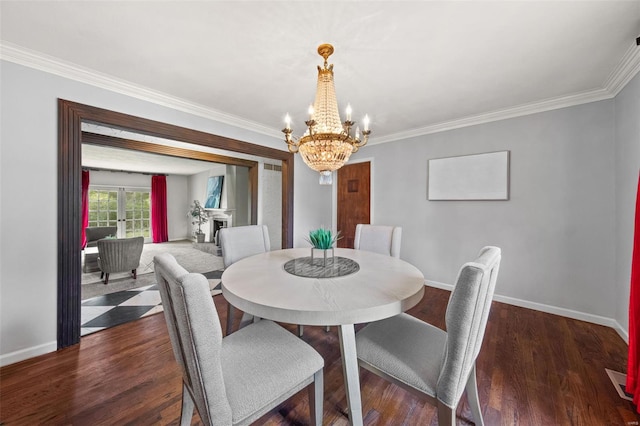 dining room with ornamental molding, a notable chandelier, and baseboards