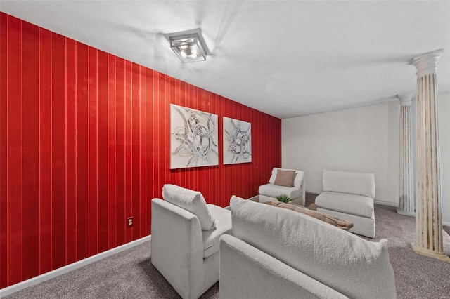 cinema room with an accent wall, decorative columns, carpet floors, and baseboards