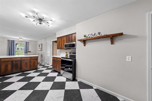kitchen with an inviting chandelier, light countertops, open shelves, baseboards, and appliances with stainless steel finishes