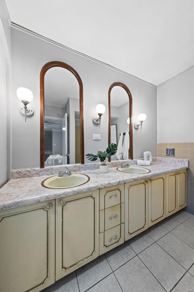 bathroom with double vanity, a sink, and tile patterned floors