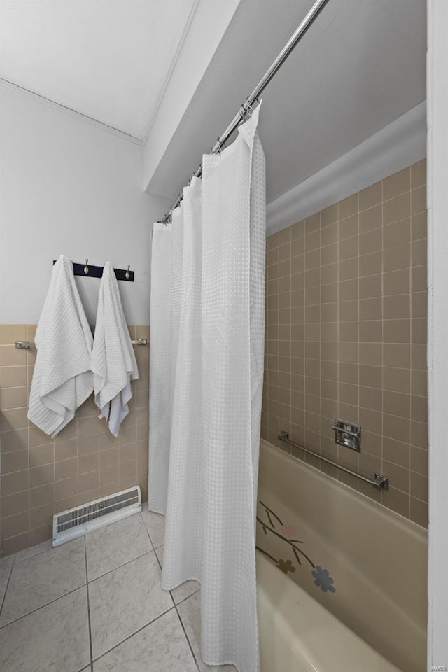 full bathroom featuring shower / tub combo, tile walls, visible vents, and tile patterned floors