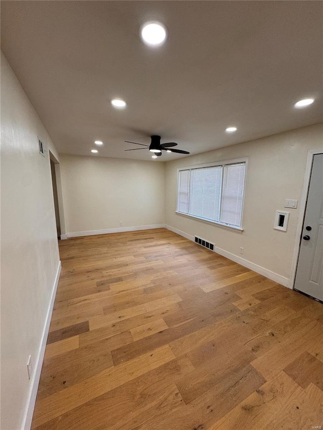 empty room featuring baseboards, visible vents, light wood-style flooring, and recessed lighting