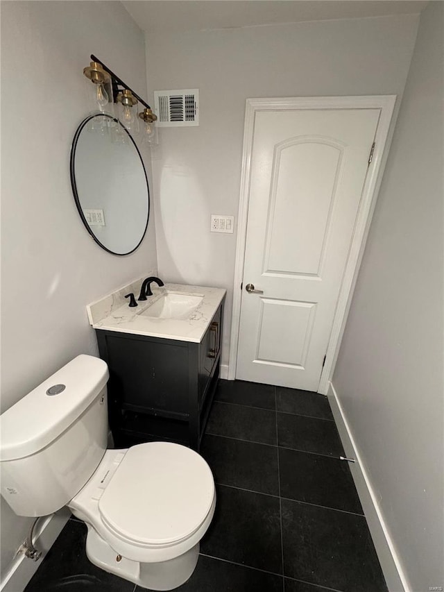 half bathroom with tile patterned floors, toilet, vanity, baseboards, and visible vents