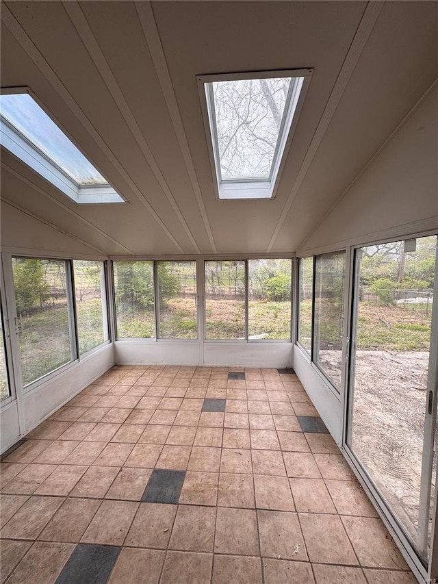 unfurnished sunroom featuring lofted ceiling with skylight