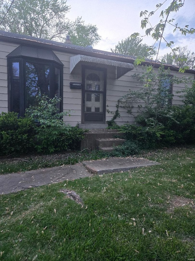 doorway to property featuring a yard