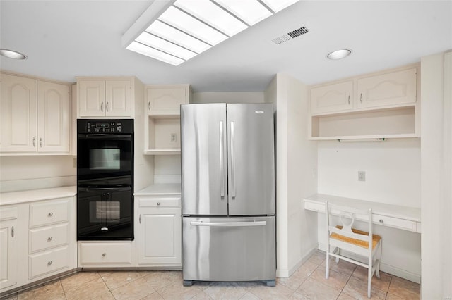 kitchen with freestanding refrigerator, dobule oven black, visible vents, and open shelves