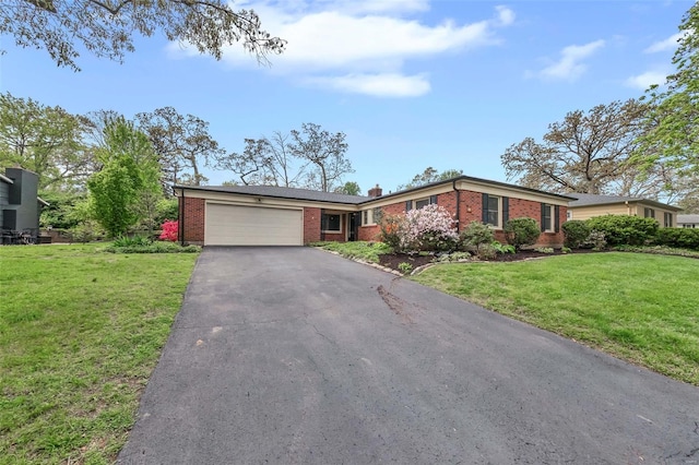 ranch-style home with driveway, a front yard, brick siding, and a garage