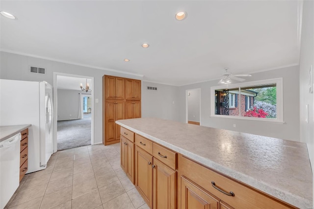 kitchen featuring white appliances, light tile patterned floors, light countertops, visible vents, and crown molding