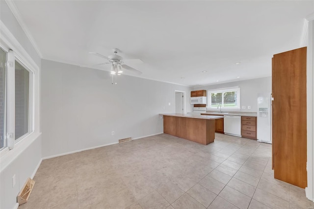 kitchen featuring white appliances, light countertops, visible vents, a peninsula, and open floor plan