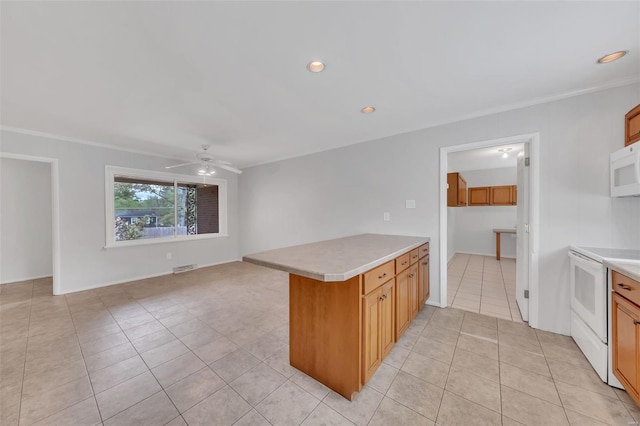 kitchen with light tile patterned floors, ceiling fan, light countertops, white appliances, and a peninsula