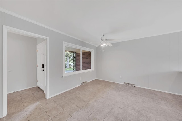 empty room featuring crown molding, a ceiling fan, visible vents, and baseboards