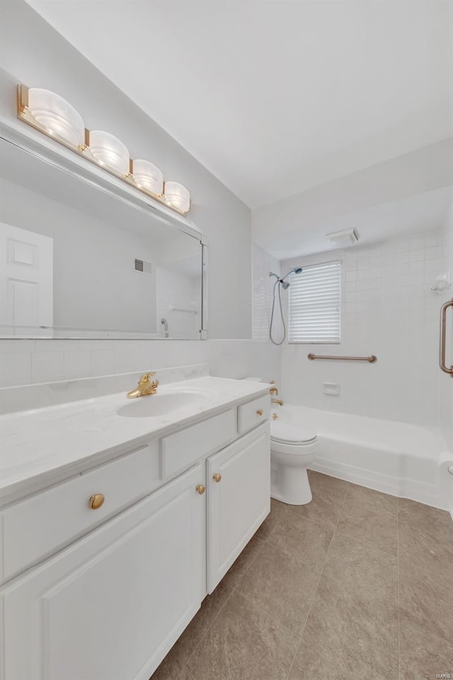 bathroom with toilet, tile patterned floors, tub / shower combination, and vanity