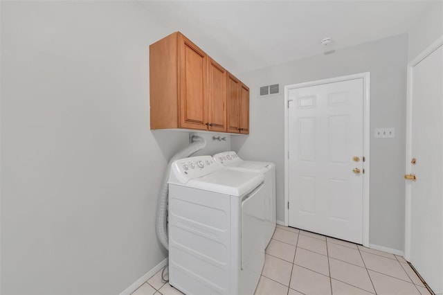 laundry room with light tile patterned flooring, visible vents, independent washer and dryer, and cabinet space