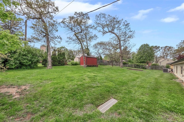 view of yard with a storage unit, fence, and an outdoor structure