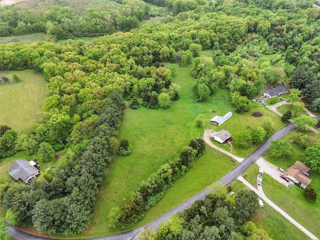 drone / aerial view featuring a wooded view