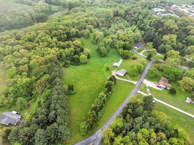 birds eye view of property featuring a view of trees