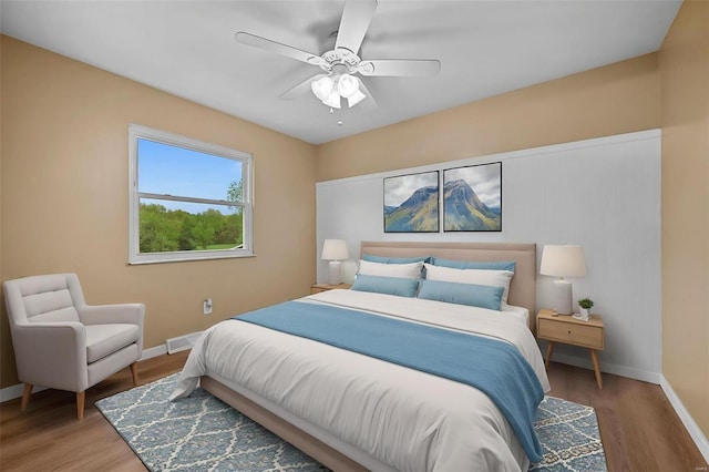 bedroom with baseboards, ceiling fan, and wood finished floors