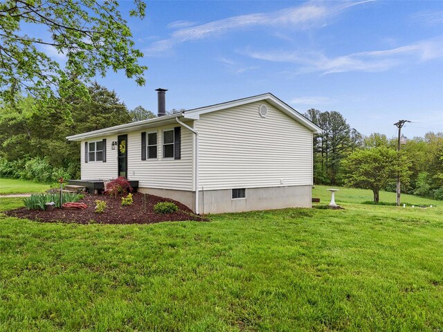 view of property exterior with a lawn