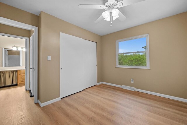 unfurnished bedroom with a ceiling fan, visible vents, baseboards, a closet, and light wood finished floors