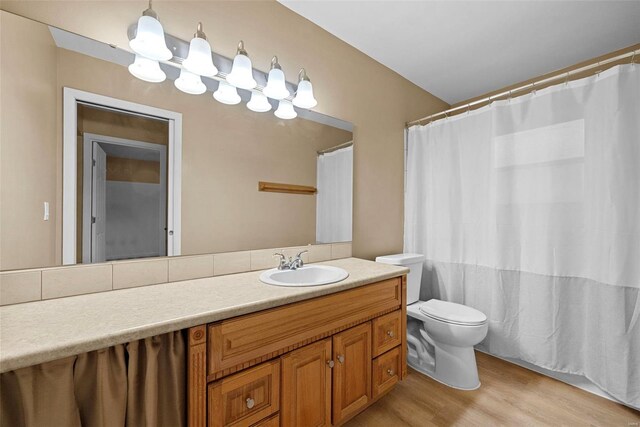 full bathroom featuring vanity, wood finished floors, and toilet