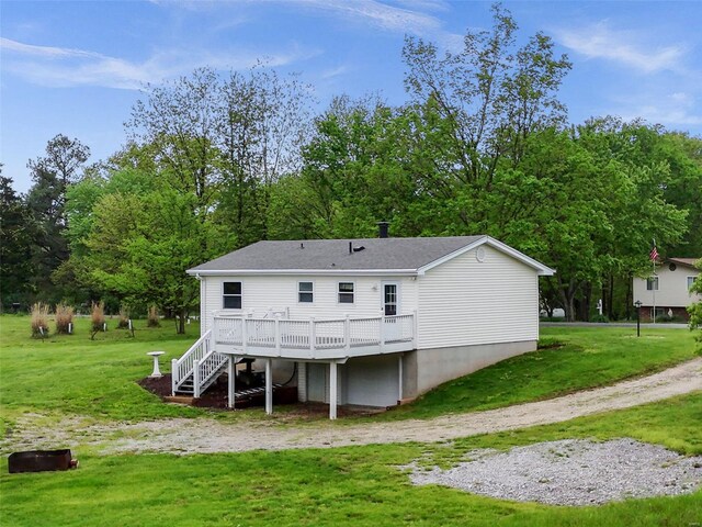 rear view of property featuring a yard, a wooden deck, stairs, and roof with shingles