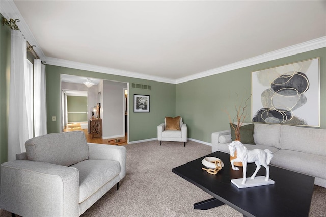 carpeted living room with visible vents, ornamental molding, and baseboards