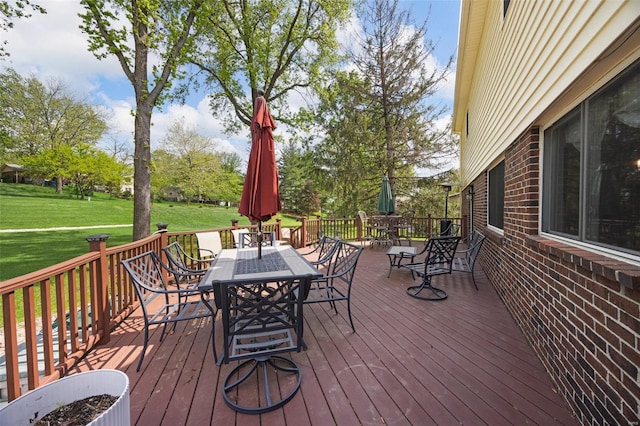 deck with a yard and outdoor dining area
