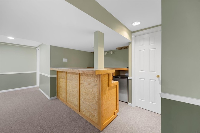 bar featuring indoor bar, fridge, baseboards, and light colored carpet