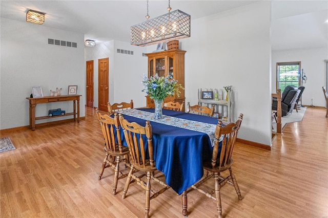 dining room featuring visible vents, baseboards, and light wood-style floors