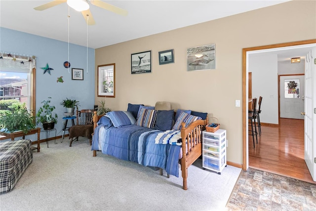 living room featuring baseboards and ceiling fan
