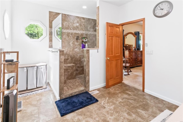 bathroom with a walk in shower and baseboards