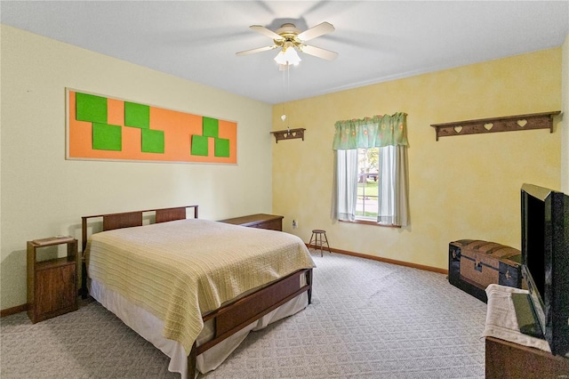 carpeted bedroom with a ceiling fan and baseboards